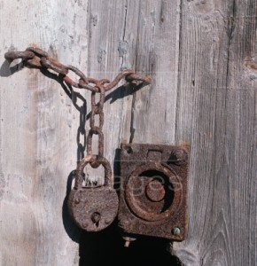 Image of a rusty old padlock on a wooden door to illustrate the Warhammer Quest Dungeon Event - Padlocked Door